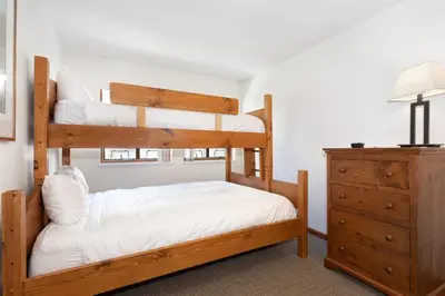 a bedroom with two bunk beds and a dresser at Northstar at Stoney Creek by Whiski Jack in Whistler