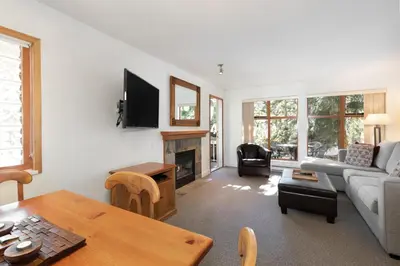 a living room with a couch and a fireplace at Northstar at Stoney Creek by Whiski Jack in Whistler