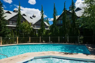 a swimming pool in front of a house at Northstar at Stoney Creek by Whiski Jack in Whistler