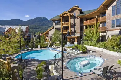 an image of a swimming pool at a resort at First Tracks Lodge, by Lodging Ovations in Whistler