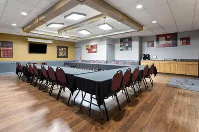 a conference room with a long table and chairs at Travelodge by Wyndham Grande Prairie in Grande Prairie