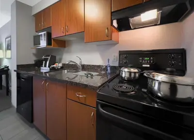 a kitchen with two pots on top of a stove at Coast Calgary Downtown Hotel & Suites by APA in Calgary