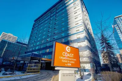 a sign in front of a tall building at Coast Calgary Downtown Hotel & Suites by APA in Calgary