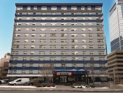 a tall building with a car parked in front of it at Coast Calgary Downtown Hotel & Suites by APA in Calgary