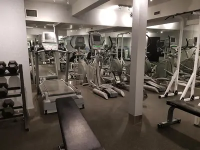 a gym with lots of treadmills and machines at Paradise Resort Club and Spa in Canmore