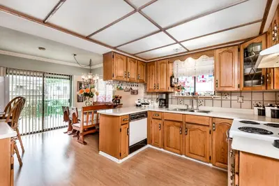 a kitchen with wooden cabinets and white appliances at Diana's Luxury Bed and Breakfast in Vancouver