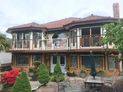 a house with a deck and a balcony at Diana's Luxury Bed and Breakfast in Vancouver