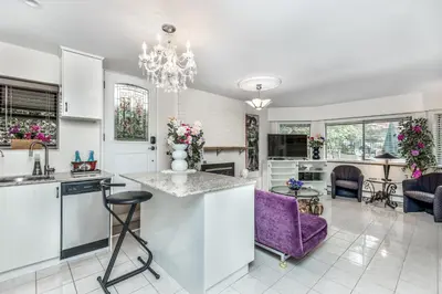 a kitchen and living room with a chandelier at Diana's Luxury Bed and Breakfast in Vancouver