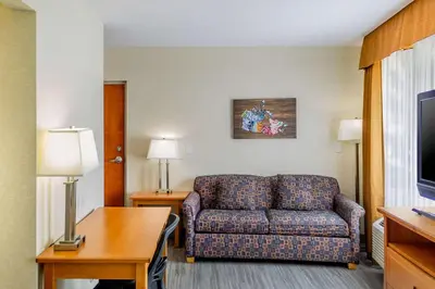 a living room with a couch in a hotel room at Econo Lodge Inn & Suites University in Calgary
