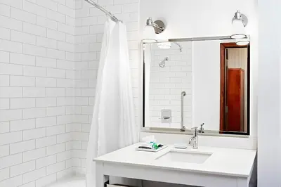 a white bathroom with a sink and a mirror at Four Points by Sheraton Calgary Airport in Calgary