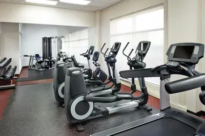 a gym with several treadmills and cardio machines at Four Points by Sheraton Calgary Airport in Calgary