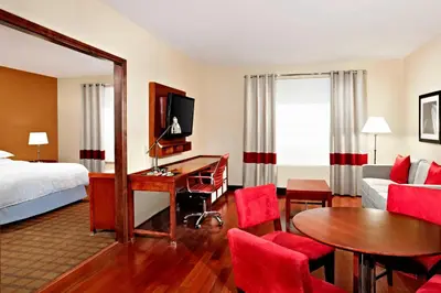 a hotel room with a bed and a desk at Four Points by Sheraton Calgary Airport in Calgary