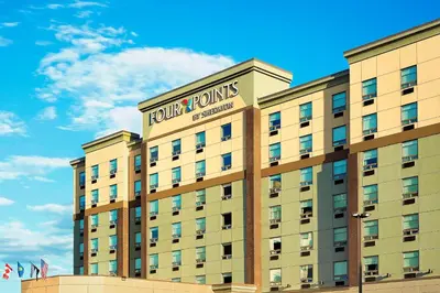a hotel building with a sign on top of it at Four Points by Sheraton Calgary Airport in Calgary