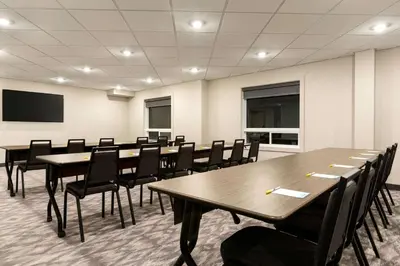 a conference room with tables and chairs in it at Days Inn by Wyndham Calgary North Balzac in Balzac