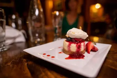 a dessert on a white plate with strawberries and whipped cream at Emerald Lake Lodge in Field