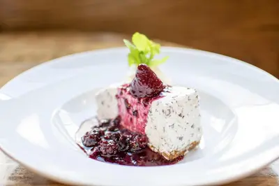 a piece of cake on a white plate on a table at The Georgetown Inn in Canmore