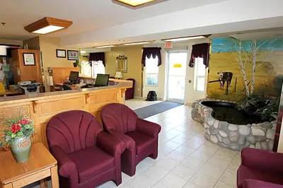 a lobby with two chairs and a waiting room at Western Budget Motel Bonnyville in Bonnyville