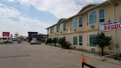 a parking lot in front of a building at Western Budget Motel Cold Lake in Cold Lake