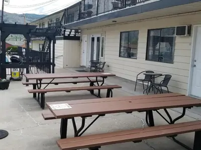 a group of picnic tables outside of a building at Osoyoos Lakeview Inn & Suites in Osoyoos