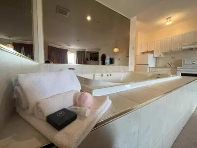 a large kitchen with a tub and a sink at Western Budget Motel Ponoka in Ponoka