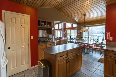 a kitchen with a table and a dining room at The Sentinel in Kaslo
