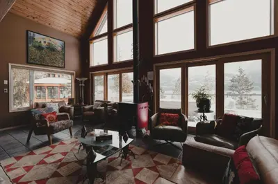 a living room filled with furniture and windows at The Sentinel in Kaslo