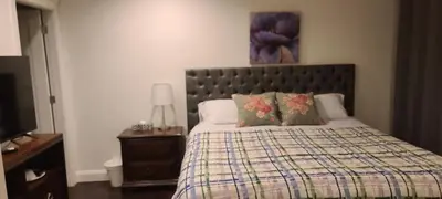 a bedroom with a bed with a quilt and pillows at White Rose House in White Rock