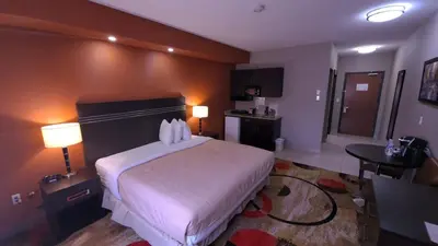 a bedroom with a large white bed in a room at Wabasca Inn in Wabasca