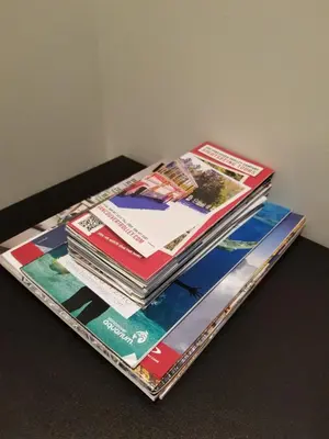 a pile of magazines sitting on top of a table at New Urban Modern Main Street House in Vancouver