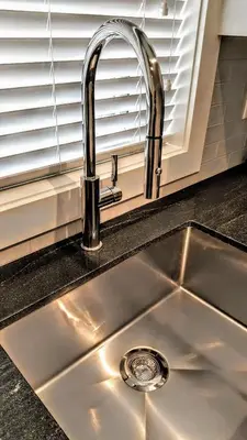 a kitchen sink with a chrome kitchen faucet at New Urban Modern Main Street House in Vancouver