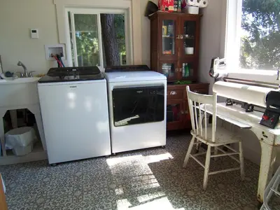 a kitchen with a white refrigerator and a sink at Malaspina Strait Cottage in Powell River