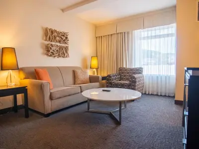 a living room with a couch and a table at Coast Kamloops Hotel & Conference Centre in Kamloops