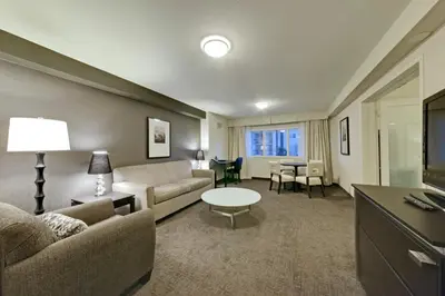 a living room with a couch and a table at Coast Kamloops Hotel & Conference Centre in Kamloops