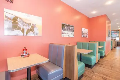 a fast food restaurant with colorful chairs and tables at Sandman Hotel and Suites Abbotsford in Abbotsford