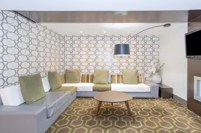 a living room with a couch and a table at Sandman Hotel and Suites Abbotsford in Abbotsford