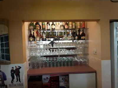 a bar with glasses and bottles on the wall at Fuller Lake Chemainus Motel in Chemainus