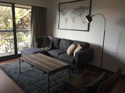 a living room with a couch and a coffee table at Twelve Oaks By Marquee Vancouver in Vancouver