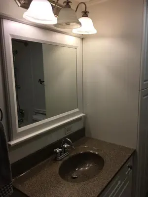 a bathroom with a sink and a mirror at Twelve Oaks By Marquee Vancouver in Vancouver