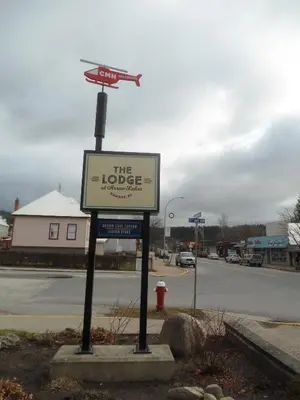 a sign for the lobige bookstore on a street at The Lodge at Arrow Lakes in Nakusp