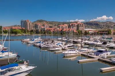 a bunch of boats are docked in a harbor at Delta Hotels by Marriott Grand Okanagan Resort in Kelowna