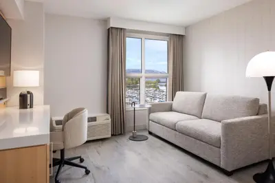 a living room with a couch and a table at Delta Hotels by Marriott Grand Okanagan Resort in Kelowna