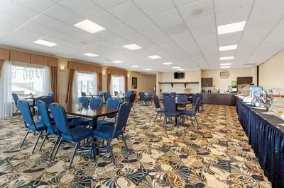 a conference room with a table and blue chairs at Best Western Grande Prairie in Grande Prairie