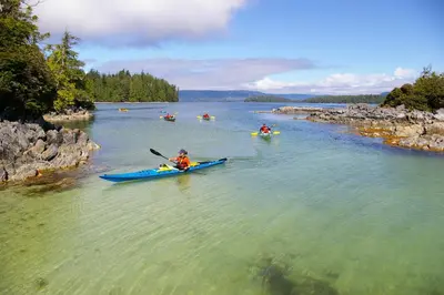 a group of people in kayaks on a river at Waters Edge Shoreside Suites in Ucluelet