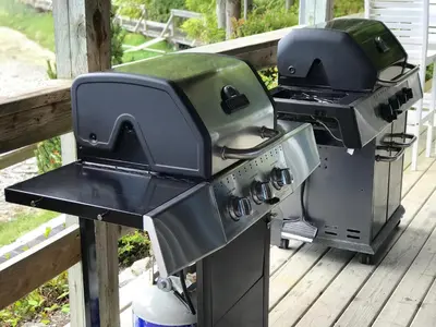 a grill and smoker sitting on a deck at Waters Edge Shoreside Suites in Ucluelet