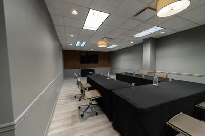 a conference room with long tables and chairs in it at The Thompson Hotel in Kamloops