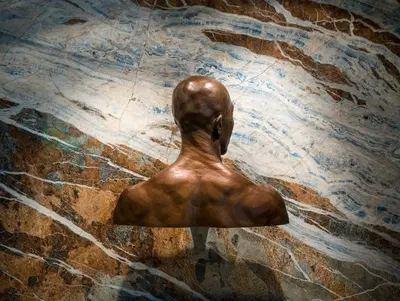 a bronze statue of a person on a marble floor at Hotel Arts Kensington in Calgary
