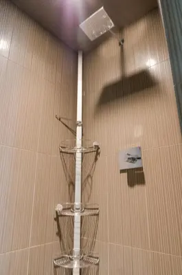 a shower with a white pole in a room at Hotel Arts Kensington in Calgary