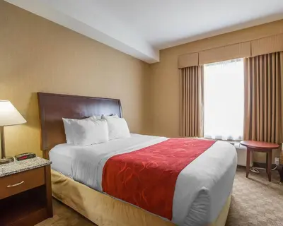 a hotel room with a large bed and a window at Comfort Inn & Suites in Airdrie