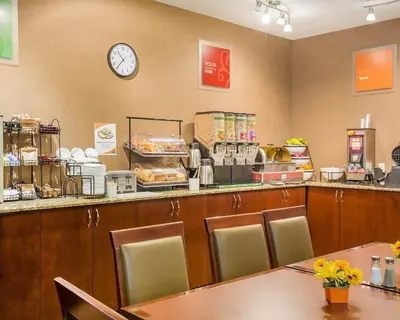 a fast food restaurant with a clock on the wall at Comfort Inn & Suites in Airdrie