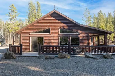 a log cabin with a bench in front of it at Mama Bear in Valemount